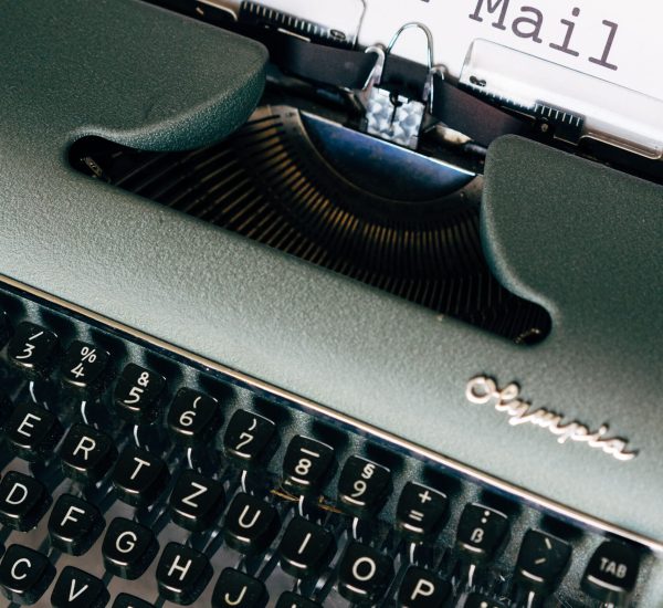 Close-up of a vintage Olympia typewriter with 'Send a Mail' typed.